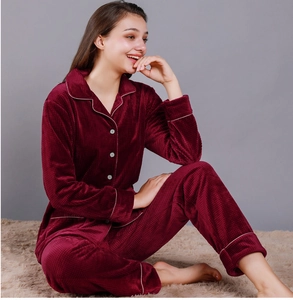 Detailed texture of burgundy waffle velvet pajama set with white piping and buttons