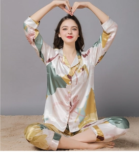 Detail of silk satin pajama collar and floral print texture on luxury sleepwear