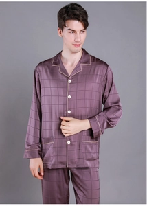Detail of men's satin pajama set with button-up shirt and yellow piping on cuffs