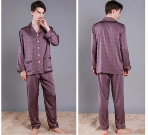 Detail of men's silk pajama set with deep purple checkered texture and golden piping