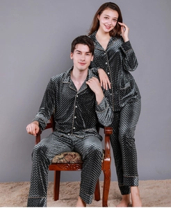 Detail of dark grey quilted velvet pajamas showing gold trim and resin buttons