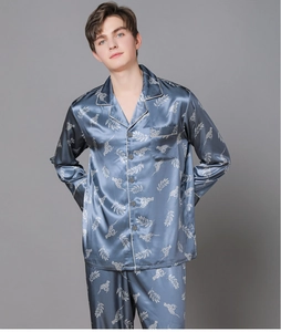 Detail of navy blue silk pajamas with leopard and leaf prints and premium satin finish