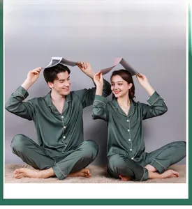 Detail of dark green silk pajama set with contrast piping for men and women