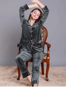 Detail of dark gray velvet pajamas set with diamond lattice texture and piping trim