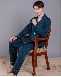 Detail of dark teal silk pajamas set featuring a classic plaid pattern and white piping