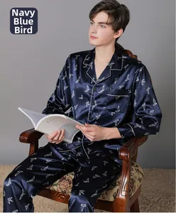 Detailed view of men's navy blue satin pajama set with white bird pattern on lapel shirt