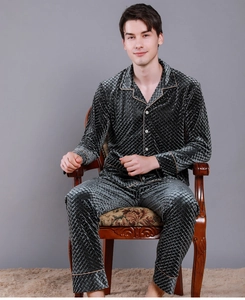 Detail of dark gray velvet pajamas with diamond embossed texture and champagne gold piping