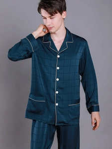 Detailed view of dark green silk pajama set with contrast piping and lattice pattern