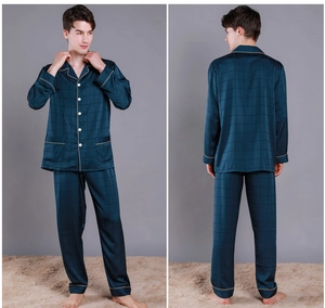 Detail of navy blue silk pajamas showing button-up lapels and gold piping accents
