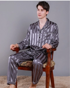 Detail of dark gray striped silk pajamas showing the collar and buttoned shirt texture