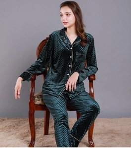 Detail of dark green velvet pajamas showing diamond pattern and gold piping