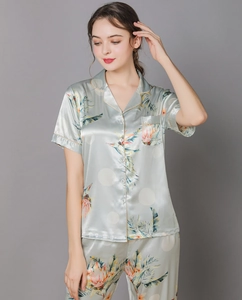 Detail of satin floral pajama set featuring tropical prints and soft glossy texture