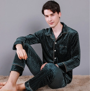 Detail of dark green velvet pajamas with diamond quilted texture and beige piping trim