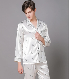 Detail of white satin men's pajama set with black piping and fashion letter prints