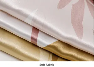 Close-up of soft champagne gold and lavender print silk satin fabric with smooth folds