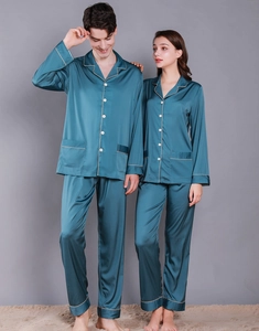 Close-up of peacock blue satin pajama set with golden piping and silk-like texture