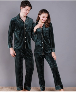 Detail of dark green velvet pajamas with diamond quilted texture and gold piping trim