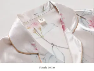 Close-up of silk pajama top with floral print, classic notched lapel and golden piping