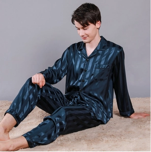 Detail of teal blue striped silk pajamas showing shiny fabric and premium chest pocket