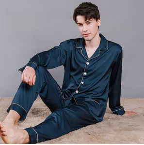 Detail of navy silk pajama set with contrast piping and button-down collar
