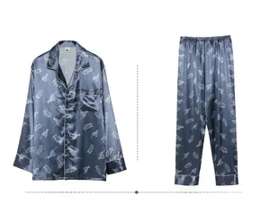 Detail of navy blue silk pajama set featuring white leopard print and piped trim finish