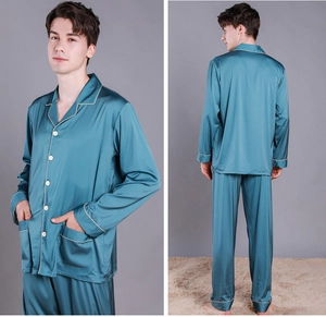 Close-up of men's silk pajamas in peacock blue with premium gold piping and pockets