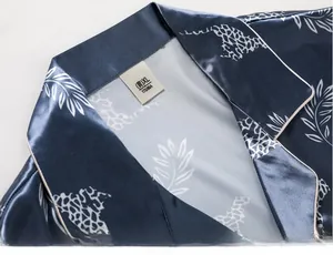Detail of navy silk pajama collar with white piping and leaf leopard print pattern