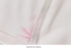 Macro detail of high-quality interior quilting on printed silk pajamas with clean stitching