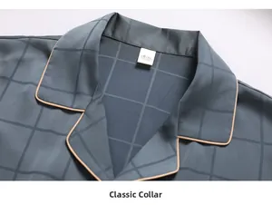 Detailed view of grey checkered silk pajama collar with brown piping and classic lapel