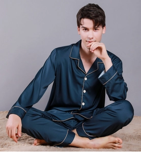 Detail of dark blue silk satin pajamas featuring V-neck collar and white buttons
