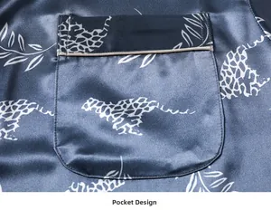 Close-up of a silk pajama pocket with leopard and leaf prints on grey-blue satin fabric