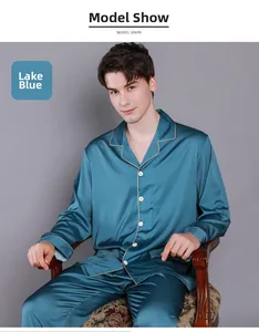 Detail of men's lake blue silk pajamas with white contrast piping and classic lapel