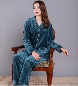 Detail of teal waffle textured pajamas set with contrast piping and white buttons