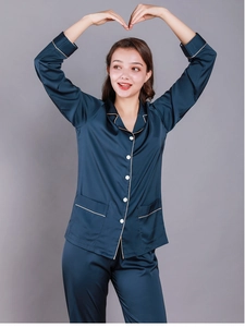 Detail of dark blue silk-like pajama set with white piping and long sleeves