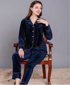Detail of navy blue velvet pajama set with diamond quilted texture and white trim