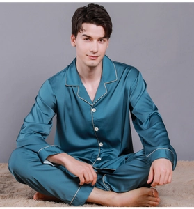 Detail of navy blue silk pajama lapel with contrasting white piping and buttons