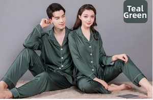 Detail of dark green silk satin pajama set with lapel collar and beige piping trim