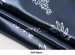 Detail of soft dark blue silk fabric with white giraffe print and smooth texture