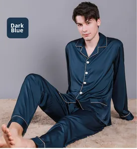 Detail of navy blue silk pajamas with golden piping and white buttons on the lapel
