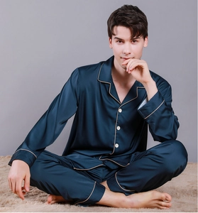 Detail of luxury navy blue satin men pajamas with elegant piping and silk texture finish