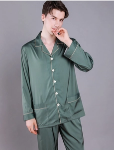 Detail of dark green silk satin pajama set with contrast piping and chest pockets