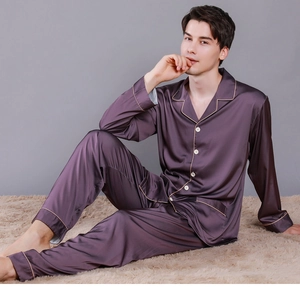 Detail of men's purple satin pajamas showing smooth texture and contrast piping finish