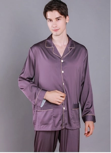 Close-up of deep purple silk pajama set for men with gold piping and pocket detail