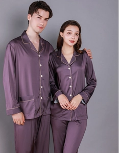 Detail of silk pajama set with contrast piping and button-down front in deep burgundy