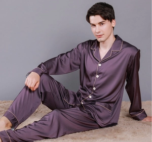 Detail view of purple silk pajamas with contrast piping and classic button-down design