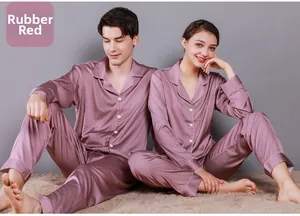 Close-up of couples in dusty rose satin pajamas with white piping and button details