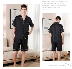 Detail view of men's black silk-like pajama set with short sleeves and contrast piping