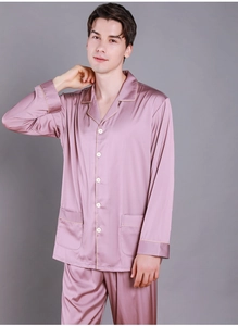 Detail of silk-like pajamas showing lapel collar, contrast piping and button-down front