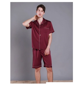 Detail of burgundy satin men's pajama set with white piping and five-button closure