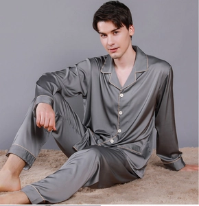 Detail of men's grey silk satin pajama set featuring contrast piping and buttoned cuffs
